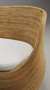 Designer rattan accent sofa with sculptural lines
