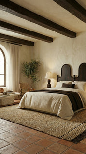 Cozy bedroom with rustic elements, including wooden beams and terracotta tiles.