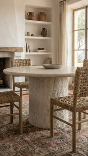 marble dining table with natural veining and solid stone base
