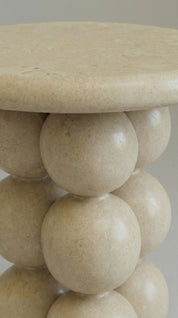 Beige stone table with spherical design 