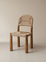 Wooden chair with woven seat and backrest on a beige background