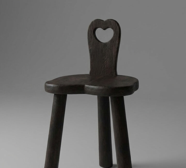 Wooden chair with a heart-shaped backrest on a gray background