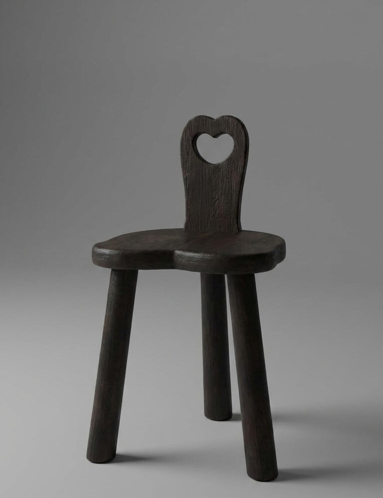 Wooden chair with a heart-shaped backrest on a gray background