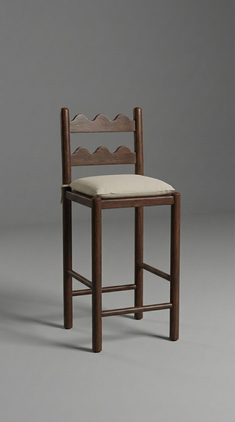 Wooden bar stool with a cushioned seat on a gray background