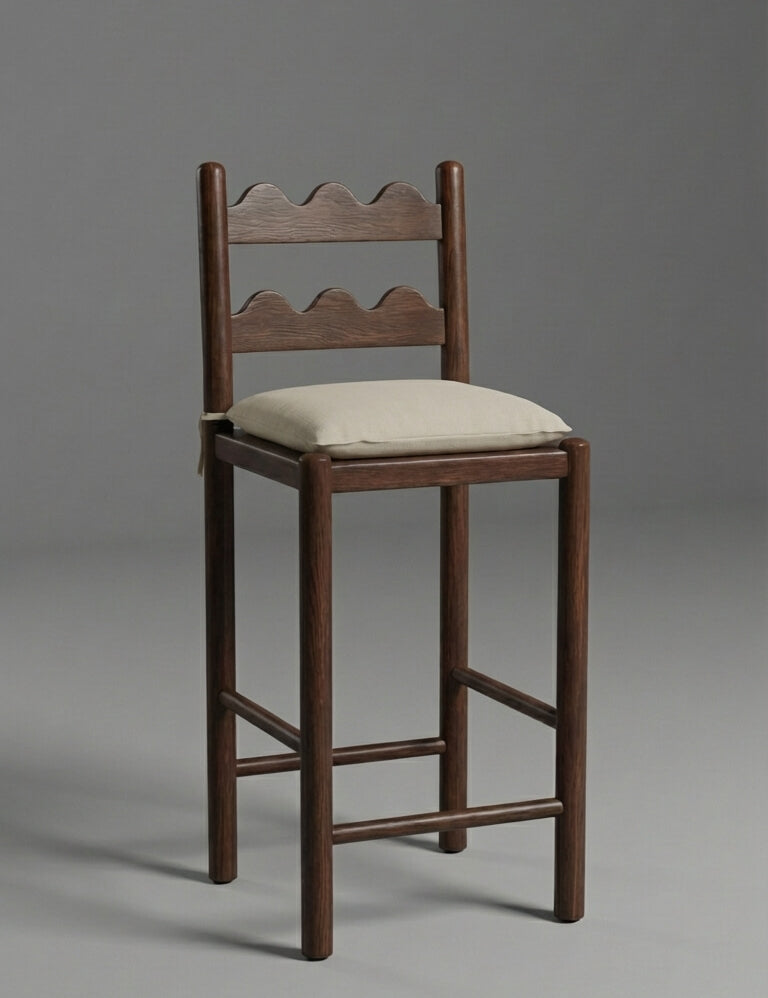 Wooden bar stool with a cushioned seat on a gray background