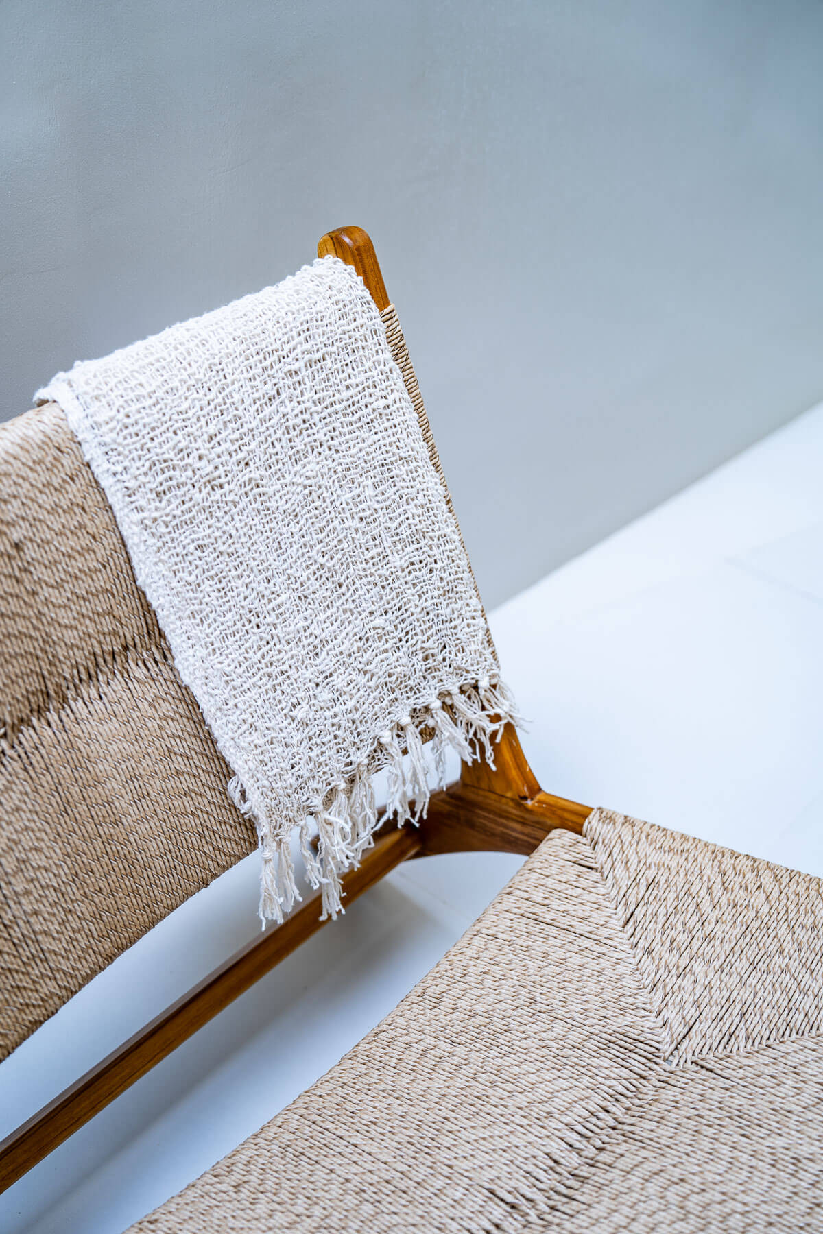 Modern teak wood chair in coastal-inspired room
