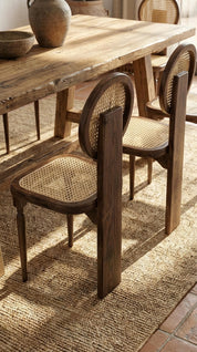 Modern teak wood armchair with curved lines
