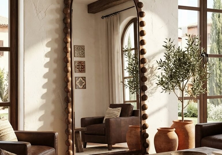 Living room with a large decorative mirror, wooden furniture, and plants.