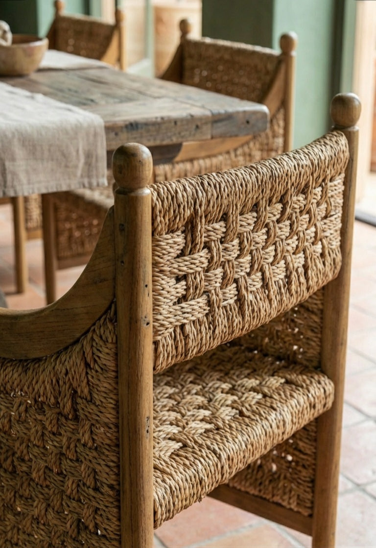 Sculptural teak wood and seagrass armchair in modern room

