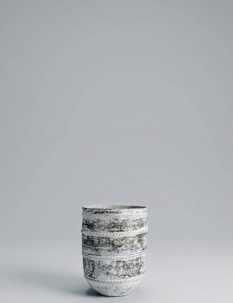 Ceramic cup with black patterns on a gray background