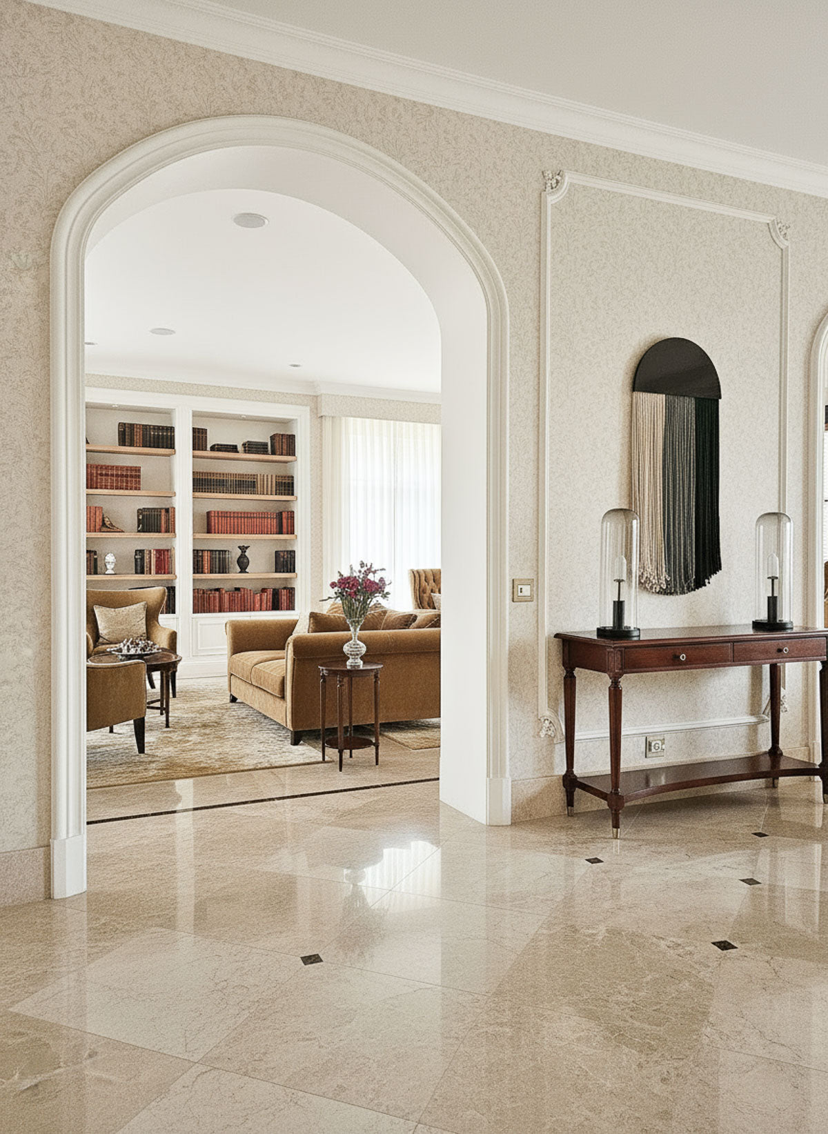 Luxurious interior with marble flooring, bookshelf, and sofa.