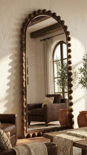 Decorative mirror with wooden frame in a living room setting
