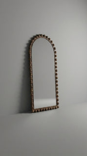 Decorative arch with a textured surface on a plain background