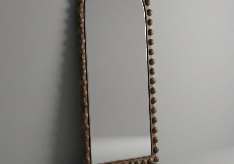 Decorative arch with a textured surface on a plain background